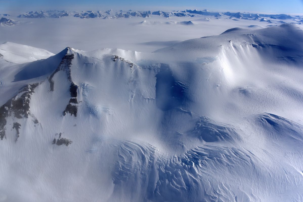 04E Flying Close To A Mountain Ridge With More Mountains In The Distance From Airplane Flying From Union Glacier Camp To Mount Vinson Base Camp